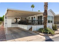 Charming home exterior featuring a covered patio, carport, and mature desert landscaping at 111 S Greenfield Rd # 190, Mesa, AZ 85206