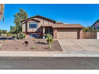 Charming two-story home featuring a brick facade, desert landscaping and a two-car garage at 13051 N 75Th Dr, Peoria, AZ 85381