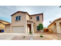 Inviting two-story home featuring a neutral color scheme, desert landscaping, and a convenient two-car garage at 16807 W Carmen Dr, Surprise, AZ 85388