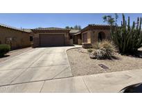 Charming single-Gathering home featuring a well-manicured front yard with xeriscape and a two-car garage at 2014 N 93Rd Dr, Phoenix, AZ 85037