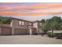Charming two-story home featuring a tile roof and three-car garage, complemented by a well-maintained front yard at 2061 E Flintlock Way, Chandler, AZ 85286