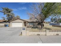Charming single-story home with brick accents, well-maintained lawn, and attached two-car garage at 2728 W Redfield Rd, Phoenix, AZ 85053