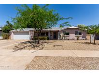 Charming single story home with desert landscaping and shade tree at 3030 E Shangri La Rd, Phoenix, AZ 85028