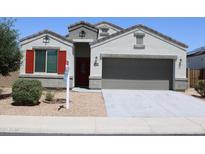 Charming single-Gathering home with a neutral-toned exterior, gravel landscaping, and a two-car garage at 30918 W Mulberry W Dr, Buckeye, AZ 85396