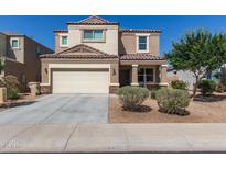 Charming two-story home featuring a two-car garage, neutral stucco, and a well-maintained front yard at 3113 N 303Rd Dr, Buckeye, AZ 85396