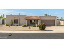 Charming single-story home featuring a well-maintained yard and covered entryway at 3821 W Woodridge Dr, Glendale, AZ 85308