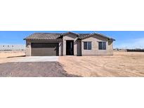 Charming single-story home with a desert landscape and attached two-car garage at 6262 S Dean Rd, Buckeye, AZ 85326