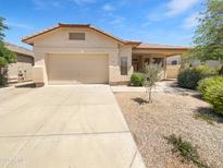 Charming single-story home featuring a two-car garage and desert landscaping at 7316 E Fledgling Dr, Scottsdale, AZ 85255