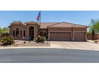 Charming single-story home featuring a spacious three car garage and desert landscaping at 7762 E Russell Cir, Mesa, AZ 85207