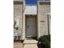 Home's entry features a secure metal screen door, offering both protection and a welcoming appeal to guests at 8110 N 31St Dr, Phoenix, AZ 85051