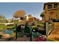 Beautiful Racquet Club sign near lush landscaping and inviting water feature on a sunny day at 9707 E Mountain View Rd # 1408, Scottsdale, AZ 85258