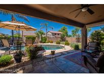 Entertainer's backyard with covered patio, refreshing pool and lush landscaping at 102 W Raven Dr, Chandler, AZ 85286