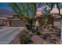Beautiful single-story home with desert landscaping, a two-car garage, and a warm, inviting facade at 102 W Raven Dr, Chandler, AZ 85286