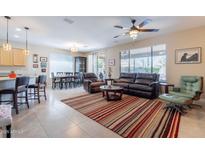 Open-concept living room with tile flooring, neutral tones, and plenty of natural light at 102 W Raven Dr, Chandler, AZ 85286