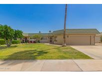 Charming single-story home with lush green lawn and attached two-car garage at 10505 W Campana Dr, Sun City, AZ 85351