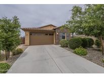 Charming single-story home with a well-maintained front yard and a two-car garage at 11470 E Yeager Cyn, Gold Canyon, AZ 85118