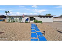 Charming single-story home featuring unique blue walkway, arched entry, and desert landscaping at 12826 N 29Th St, Phoenix, AZ 85032