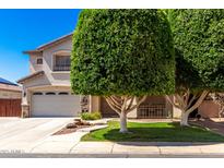 Charming two-story home boasts a landscaped yard and attached two-car garage at 14604 W Banff Ln, Surprise, AZ 85379