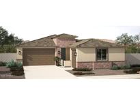 Charming single-story home featuring a two-car garage, desert landscaping, and a stone-accented facade at 18063 W Larkspur Dr, Goodyear, AZ 85338