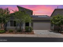 Inviting single-Gathering home with a desert landscape, a two-car garage, and solar panels for energy efficiency at 2181 N 211Th Dr, Buckeye, AZ 85396