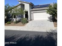 Charming single-story home with modern architecture, solar panels, and a two-car garage at 2181 N 211Th Dr, Buckeye, AZ 85396
