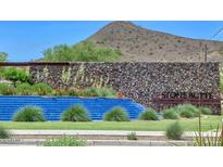 Stone Butte community waterfall with lush greenery and stone accents; a serene neighborhood entrance at 24314 N 21St Pl, Phoenix, AZ 85024