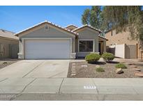 Charming single-story home with a two-car garage and low-maintenance desert landscaping at 2625 E Beverly Rd, Phoenix, AZ 85042