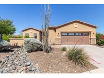 Charming single-story home featuring a two-car garage and low-maintenance desert landscaping at 29159 N 128Th Ln, Peoria, AZ 85383