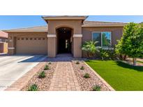 Charming single-story home featuring a low-maintenance front yard with vibrant artificial turf and desert landscaping at 3081 E Desert Broom Pl, Chandler, AZ 85286