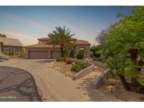 Elegant home featuring a tile roof, manicured landscaping, and a private entry walkway, perfect for curb appeal at 3514 E Desert Broom E Way, Phoenix, AZ 85044