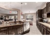 Well-equipped kitchen features stainless steel appliances, granite countertops, and a stylish breakfast bar at 41638 N Emerald Lake Dr, Anthem, AZ 85086