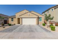 Charming single-story home featuring a well-manicured yard and a two-car garage at 4514 W Hazel Ln, San Tan Valley, AZ 85144