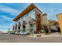 Contemporary condo building featuring copper and concrete facade, complemented by modern architectural design at 4747 N Scottsdale Rd # 4009, Scottsdale, AZ 85251
