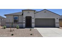 Charming single-story home featuring a stucco facade, arched entryway, and well-manicured desert landscaping at 5827 E Axle Ln, San Tan Valley, AZ 85140