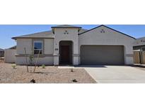 Charming single-story home featuring a two-car garage and desert landscaping for low maintenance at 5827 E Axle Ln, San Tan Valley, AZ 85140