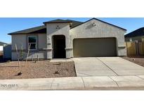 Charming single-story home featuring a neutral stucco facade, attached two-car garage, and low-maintenance landscaping at 5827 E Axle Ln, San Tan Valley, AZ 85140