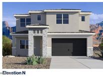 Modern two-story home featuring gray stucco, stone accents, a dark garage door and desert landscaping at 7393 W Buckhorn Trl, Peoria, AZ 85383