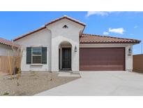 Charming single-story home featuring a tile roof, neutral stucco, and a two-car garage at 7638 W Park St, Laveen, AZ 85339