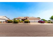 Charming single-Gathering home boasts a three-car garage, well-maintained landscaping, and a welcoming facade at 8053 E Dover St, Mesa, AZ 85207