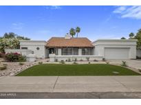 Charming single story home with terra cotta roof, two-car garage, and meticulously xeriscaped yard at 8648 E San Jacinto Dr, Scottsdale, AZ 85258