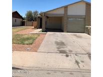 Modest single level home with mature landscaping and a two car garage at 13208 N 51St Ln, Glendale, AZ 85304