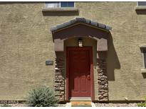 Inviting front door with stone accents and covered entryway, offering a warm welcome to this charming home at 1350 S Greenfield Rd # 2205, Mesa, AZ 85206