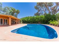 Inviting swimming pool with a spacious patio, perfect for outdoor relaxation and entertainment at 1417 W Rose Ln, Phoenix, AZ 85013