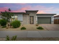 Charming single-Gathering home featuring brick accents, a two-car garage, and desert landscaping at 14177 W Calle Lejos --, Surprise, AZ 85387