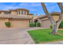 Charming home with a tan exterior, two-car garage, and well-maintained landscaping at 15240 N Clubgate Dr # 168, Scottsdale, AZ 85254
