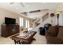 Cozy living room featuring comfortable seating, an entertainment center, and a staircase with ornate railing at 15550 N Frank Lloyd Wright N Blvd # 1040, Scottsdale, AZ 85260