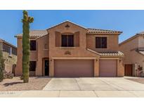 Two-story home featuring a tile roof, two-car garage, and desert landscaping at 18903 N Shelby Dr, Maricopa, AZ 85138