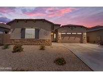 Charming single-story home with a neutral color palette, a two car garage, and low-maintenance landscaping at 18916 W Laurel Ln, Surprise, AZ 85388