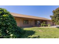 Charming single-story home features a well-manicured lawn and inviting front porch at 19006 E Karsten Dr, Queen Creek, AZ 85142
