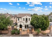Stunning two-story home featuring a Spanish-style tile roof and a charming gated front yard at 2004 E Heartwood Ln, Phoenix, AZ 85022